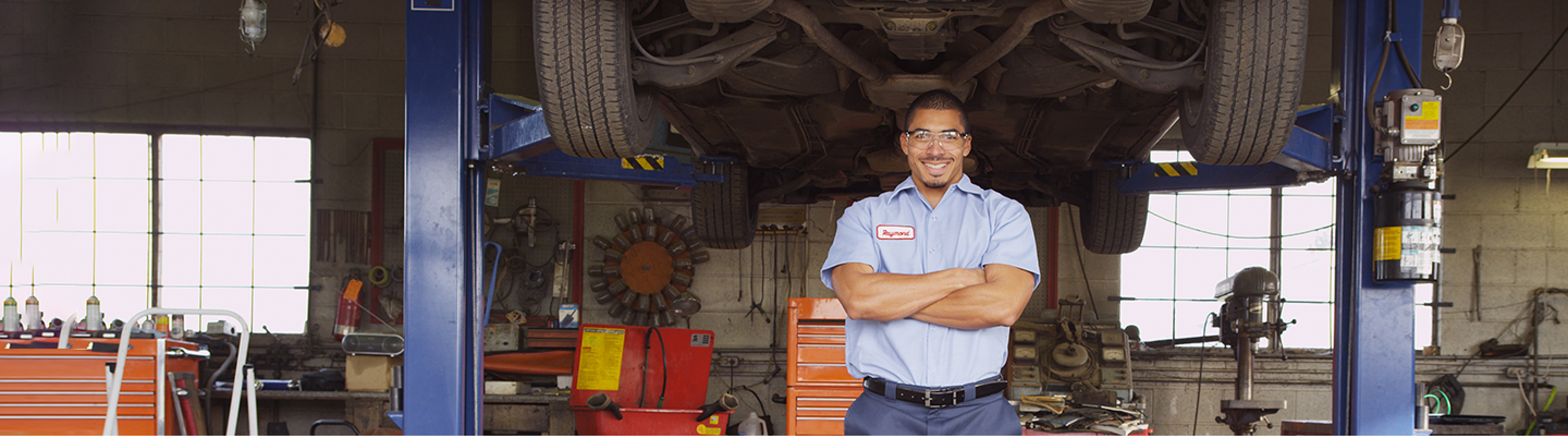 mechanic smiling with arms crossed