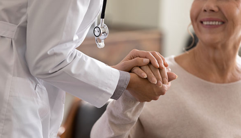 doctor holding an old lady hand