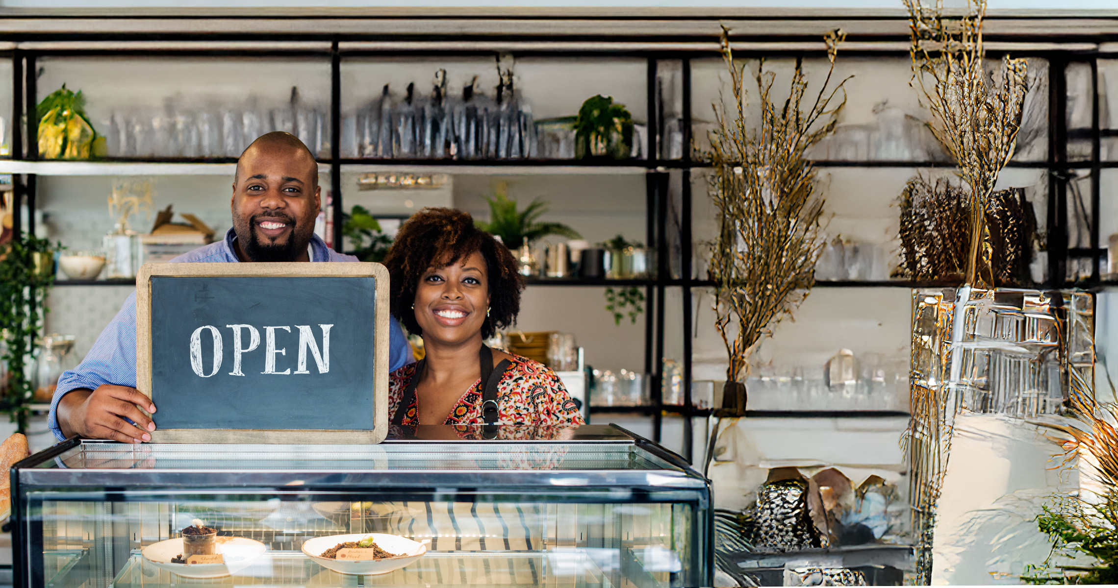 Businessowners with a open sign 