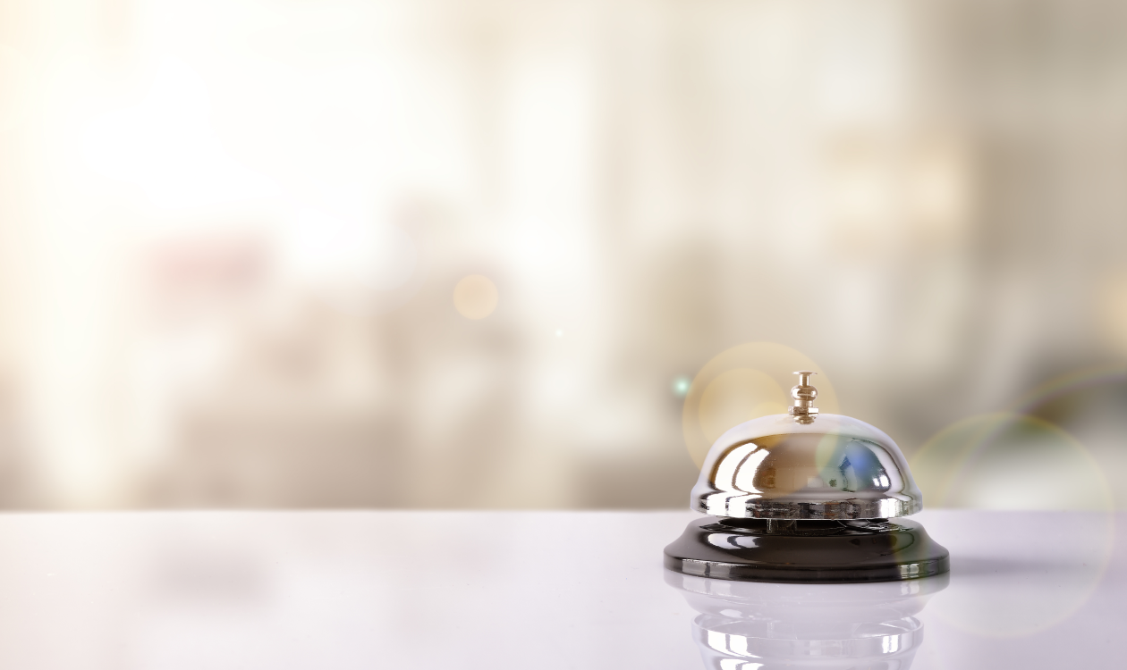 Silver doorbell on a white table.