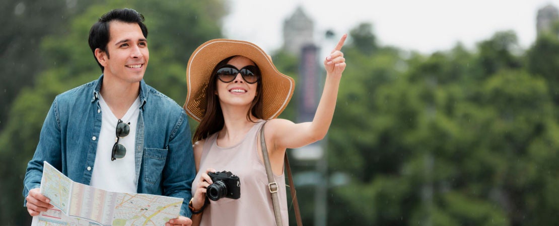 couple in vacation exploring with a map in hand