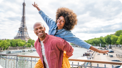 Man carrying his partner with the Eiffel tower behind