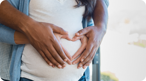 Couple hugging each other while man hold woman's belly.