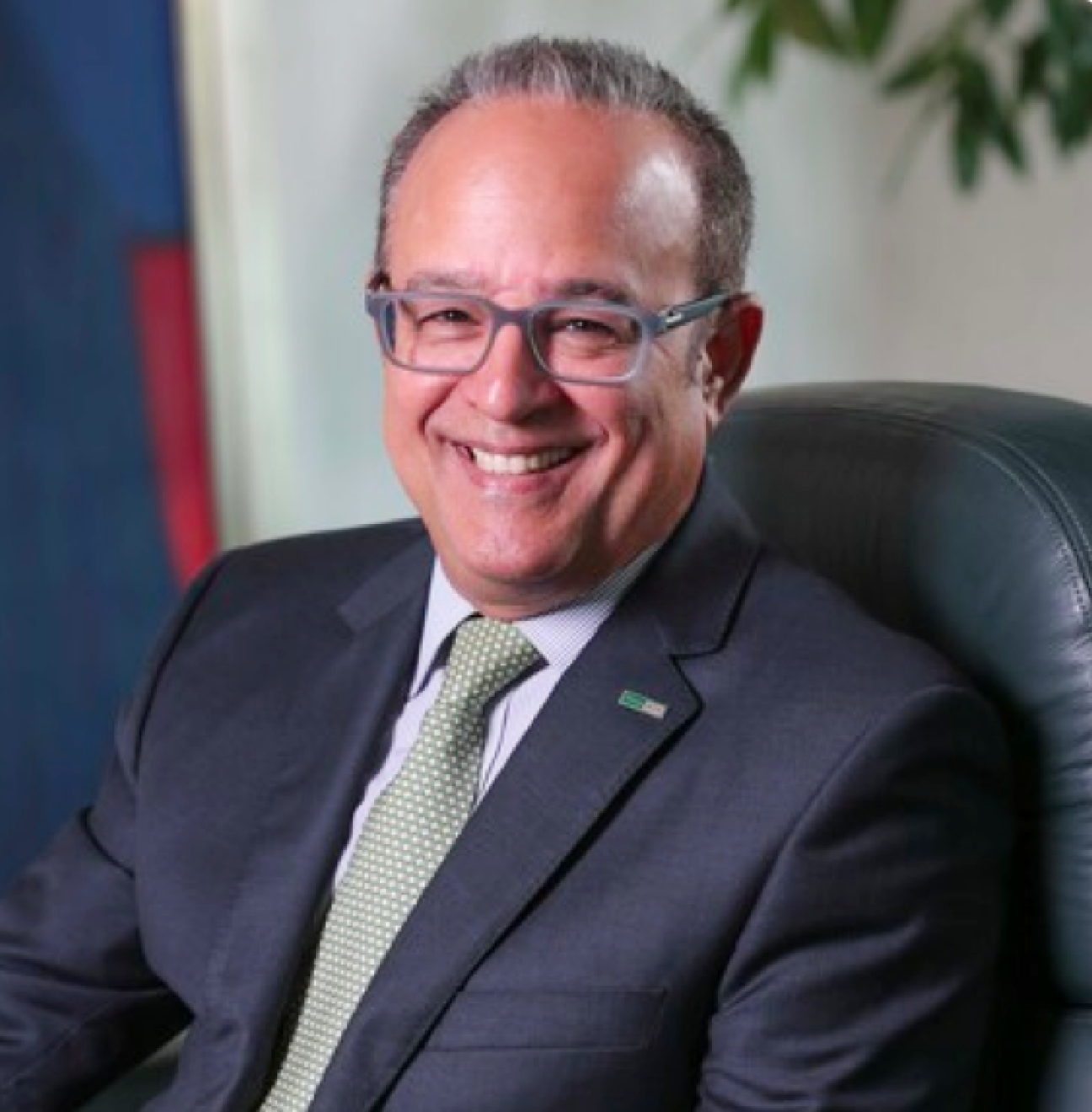 FirstBank President Aurelio Alemán smiling.