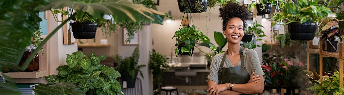  woman smiling with plants in the background