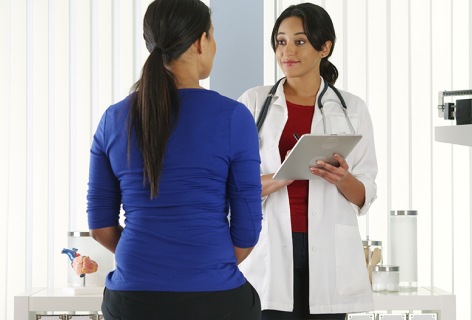 Female doctor checking a female patient