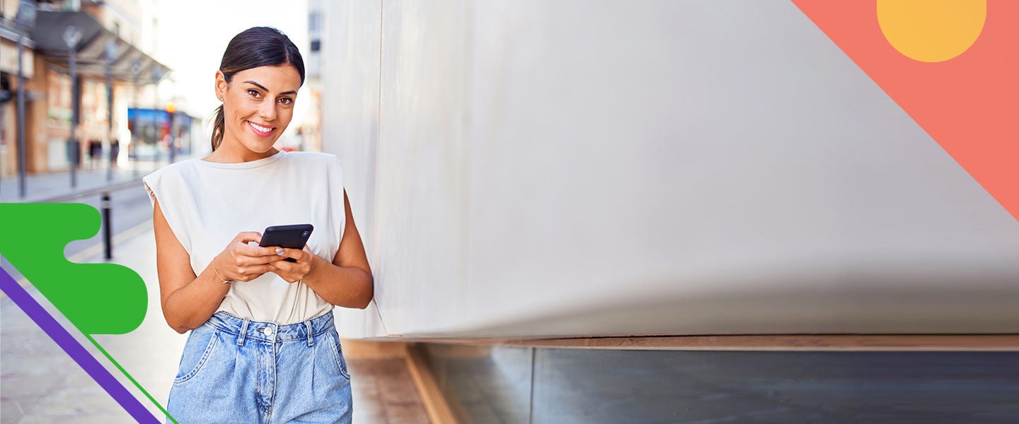 Girl smiles while holding her mobile