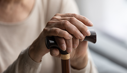 Woman hands holding a walking stick 