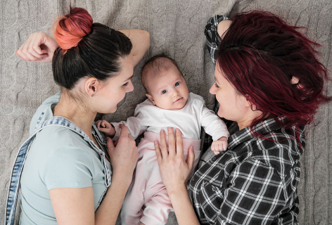 Couple of ladies caring a little baby