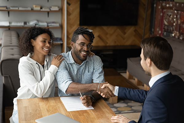 Advisor shaking hands of man and woman