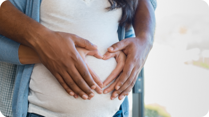 Couple hugging each other while man hold woman's belly.