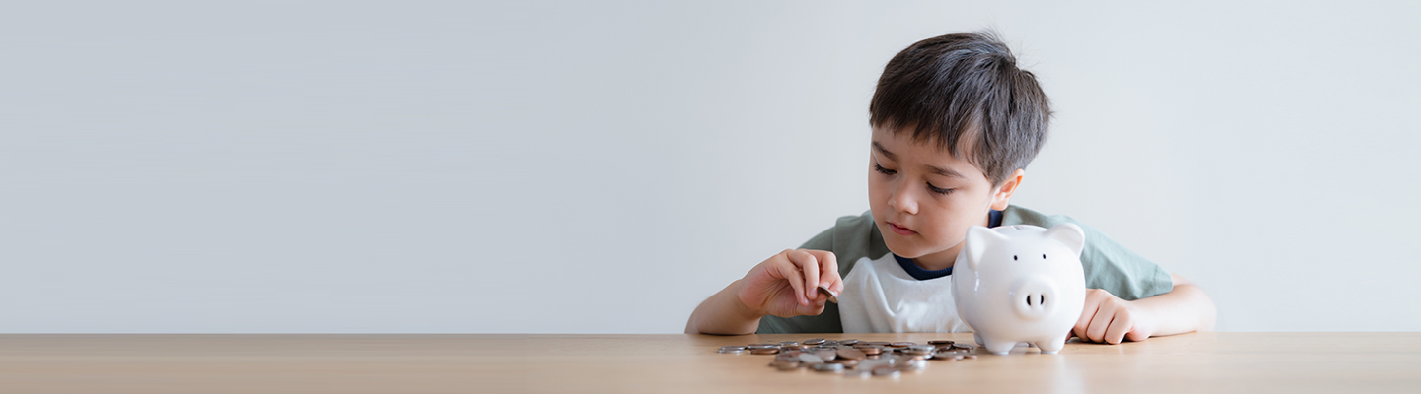 Boy counting coins from his piggy bank.