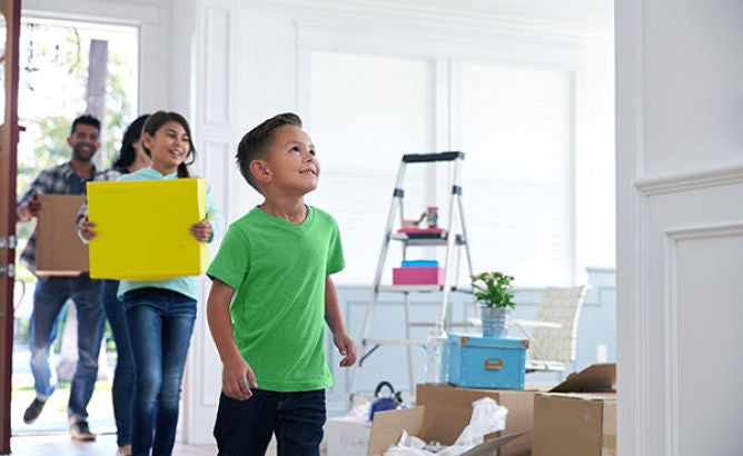 Happy family entering home in a row