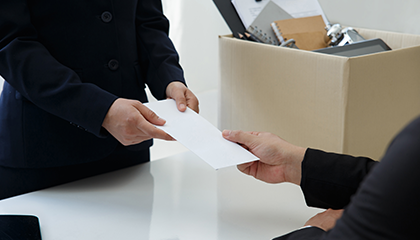 Person giving an envelope to another person