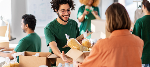 volunteer giving box of food