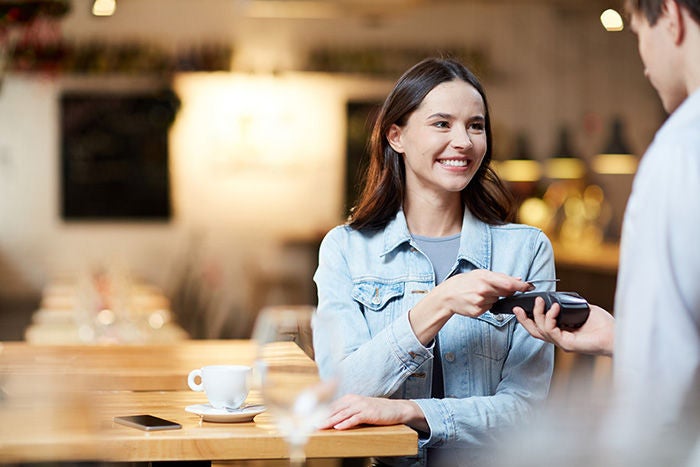 Man paying with card at a store with dataphone