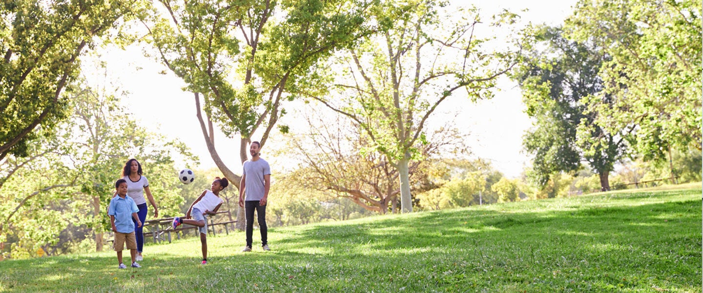 family playing in grove