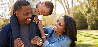 Happy family walking through the park