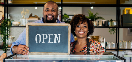 Businessowner with a open sign