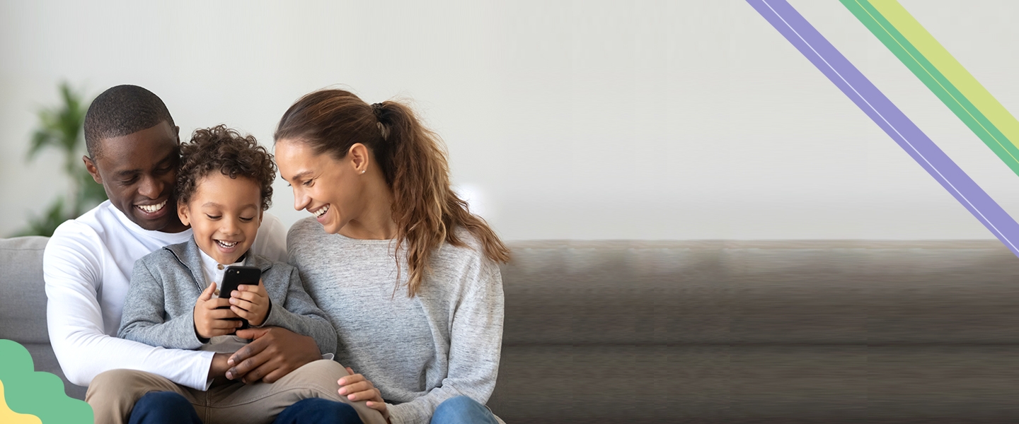 family sitting on sofa