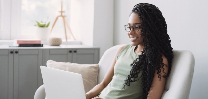 Woman in a sofa using a laptop