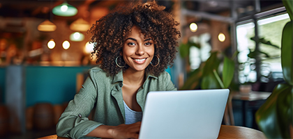 Woman smiling  with a computer
