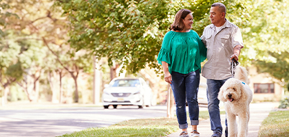 Couple walking a dog