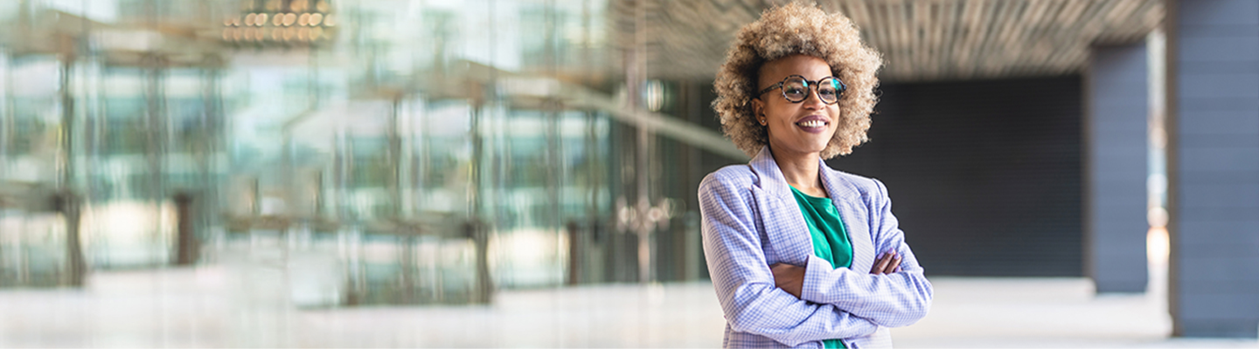 Woman with glasses smiling.